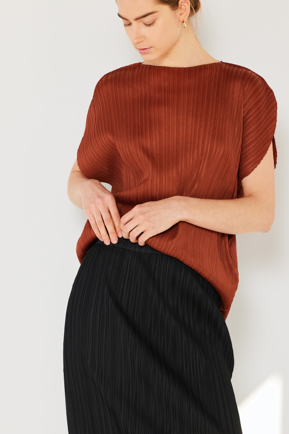 This oversized dolman sleeve top is a trendy and chic choice for a relaxed and stylish look. The ribbed texture adds dimension and the pleats add sophistication to the design. Dress it up with tailored pants or down with denim for any occasion.