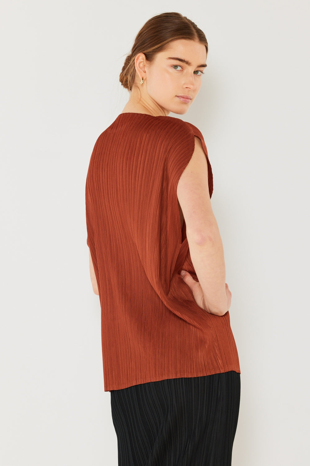 This oversized dolman sleeve top is a trendy and chic choice for a relaxed and stylish look. The ribbed texture adds dimension and the pleats add sophistication to the design. Dress it up with tailored pants or down with denim for any occasion.