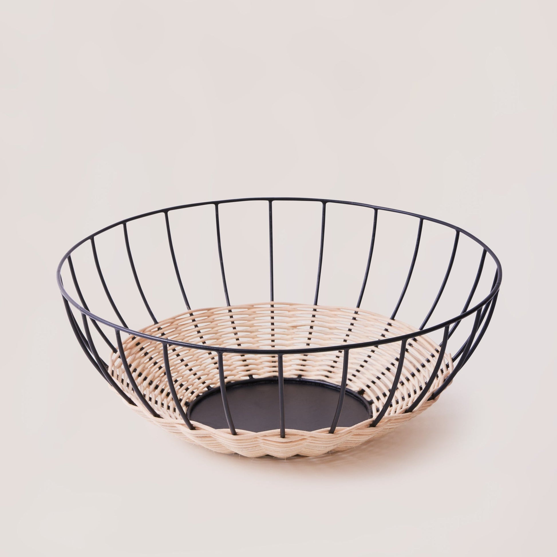 The Cabo Rattan Basket turns your grocery store produce into a beautiful still-life piece. Woven with natural rattan, this airy basket would elevate your centrepiece display of fruit, vegetables or ornamental objects. 
    * Natural Rattan on Powder coated Iron
    * Size:  35 cms Width x 12 cms Height / 13.8" round x 4.72" Height
Note: Please keep away from high moisture places. Wipe clean with a dry soft cloth. 