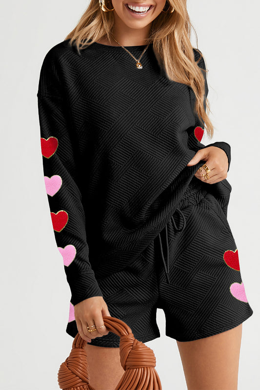 Our Full Of Love Round Neck Top and Drawstring Shorts Set is here and it's ~all the rage~! This fabulously comfy two-piece features a super-soft round neck top and drawstring shorts, perfect for bringing a bit of lovin' to your laidback style game. So relax and kick it in this stylish set! heart sweater, black sweater,