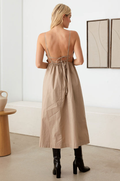 The Mabel Backless Cami Dress is a stylish and contemporary option for a variety of occasions, allowing you to show off some skin while still maintaining a sleek and elegant look. This style of dress is great for summer events, parties, or a night out on the town.