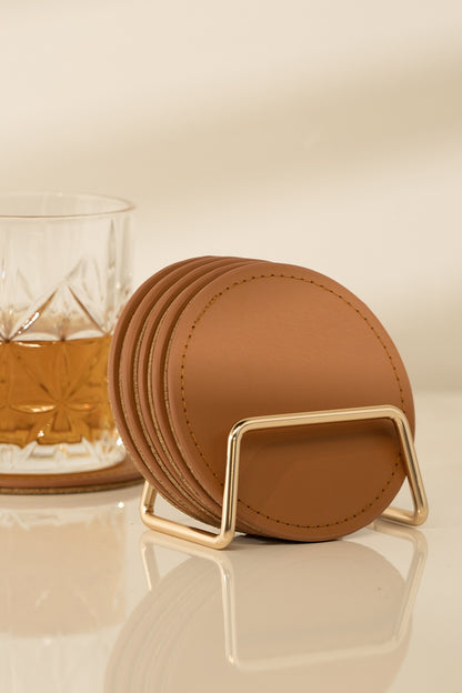 These coasters are made from high-quality vegan leather that is both durable and easy to clean, designed to protect your furniture from spills, stains, and scratches. They come in a classic round shape, lightweight with cork backing, making them perfect for everyday use or special occasions. Simply wipe them down with a damp cloth or sponge to remove any spills or stains. *Each set includes 6 coasters and 1 gold metal stand.