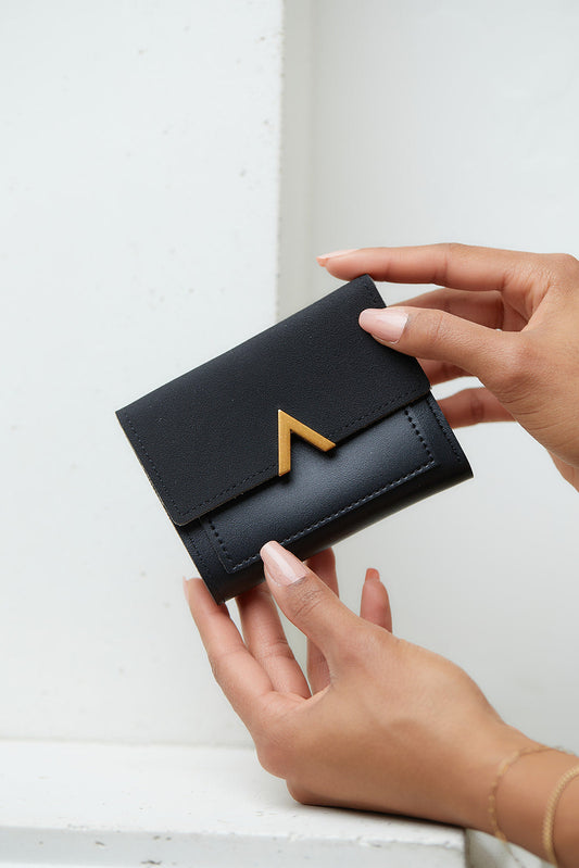 The True North Wallet is sleek and functional all rolled into one adorable little design. Available in four classic colors. With its snap and zipper closures, multiple card and cash slots and cute gold accents, this wallet might be your new favorite!  Bi-fold Snap Closure