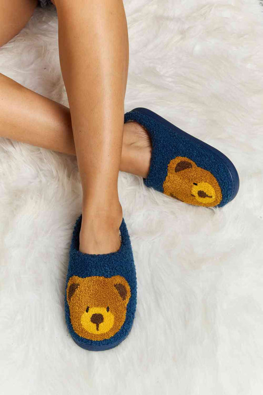 These adorable slippers feature a delightful teddy bear print, adding a touch of cuteness to your cozy indoor moments. Crafted from ultra-soft plush material, they provide a gentle, soothing feel to your feet, making them ideal for relaxation and lounging. The slip-on design ensures easy wearing, while the sturdy yet flexible sole offers excellent support and traction. Treat yourself or someone special to these irresistibly snug and charming slippers for a delightful winter experience.