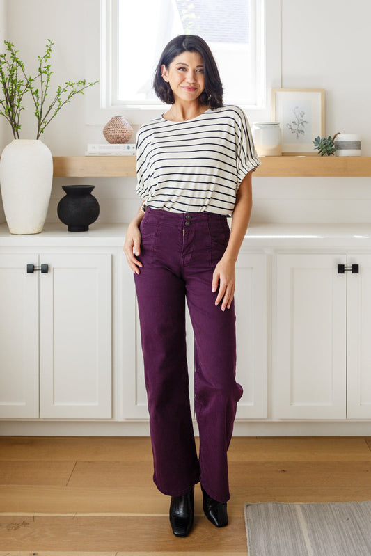 Treat yourself to a timeless style with our Petunia High Rise Wide Leg Jeans. Comfort meets sophistication in this modern design, featuring a tailored waistband, welted pockets, double button waistband, and contour seaming for an ultra-flattering fit. The deep plum hue offers a refined look that never goes out of style. Ready for a new denim staple? Look no further.  High Rise Double Button Closure Zip Fly