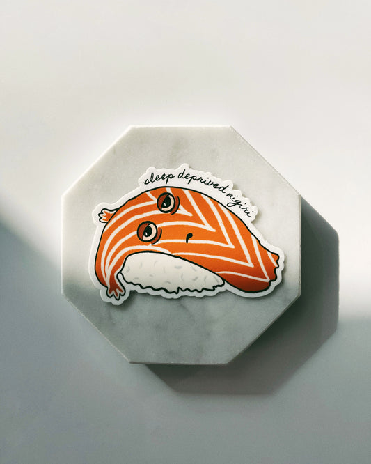 This thick and durable vinyl die-cut sticker captures a relatable moment - a very sleep-deprived nigiri. Not only is it a fun and humorous addition to your sticker collection, but it's also built to last. You can stick it on your laptop, water bottle, or any other smooth surface and trust that it can withstand scratching, rain, and sunlight without fading or peeling. Get your hands on this high-quality sticker and add a touch of personality to your belongings! Custom Vinyl Stickers